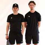 Two men wearing black athletic outfits with a logo, standing side by side against a plain background.