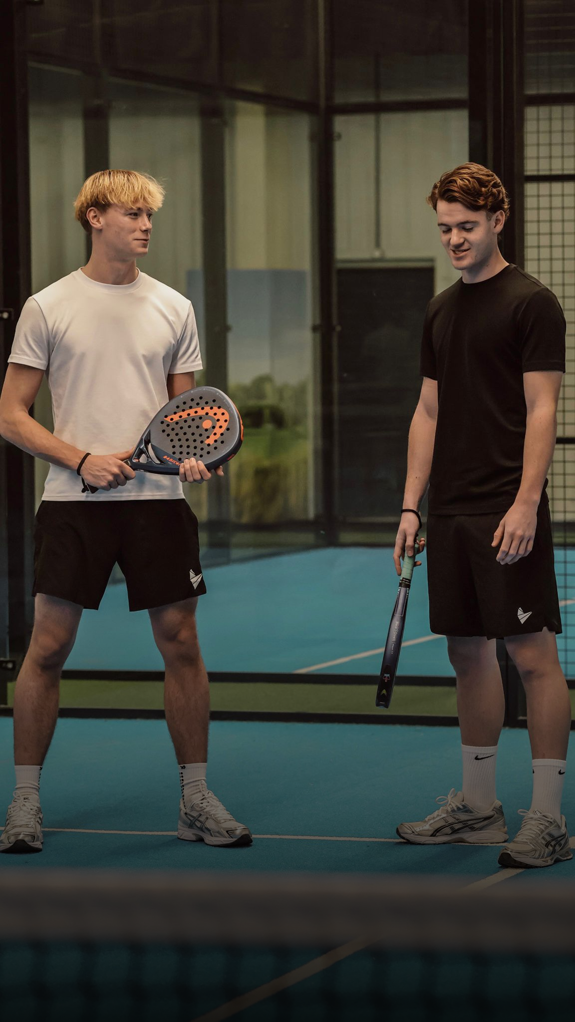 Padel Source founders wearing Padel Source performance clothing on court.