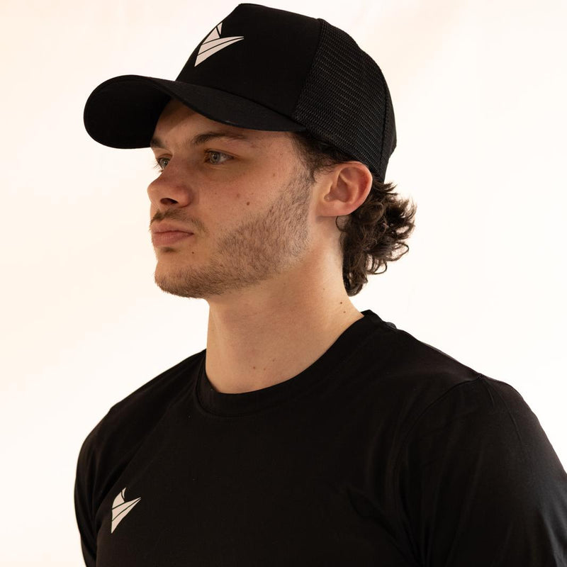 Man wearing a black t-shirt and Padel Source Pro Performance Cap with a logo on a white background
