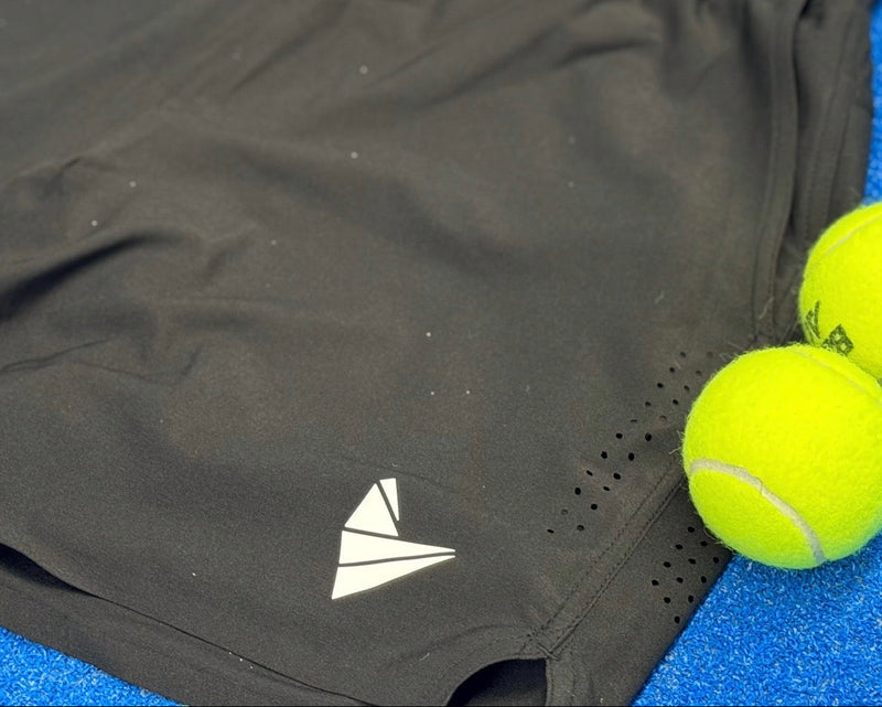 Close up of the Pro Performance 7" Shorts. Featuring laser-cut ventilation zones and padel balls next to a padel-engineered pocket.