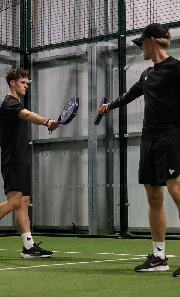 2 Padel Source Co-Founders touching rackets on a padel court.